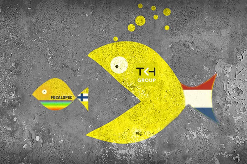 Small fish with FocalSpec logo is being swallowed by larger fish with TKH logo representing the acquisition of the smaller company