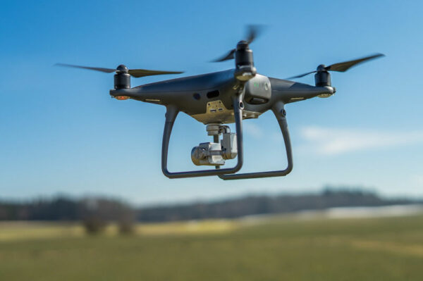 A drone in flight with camera fixed below it