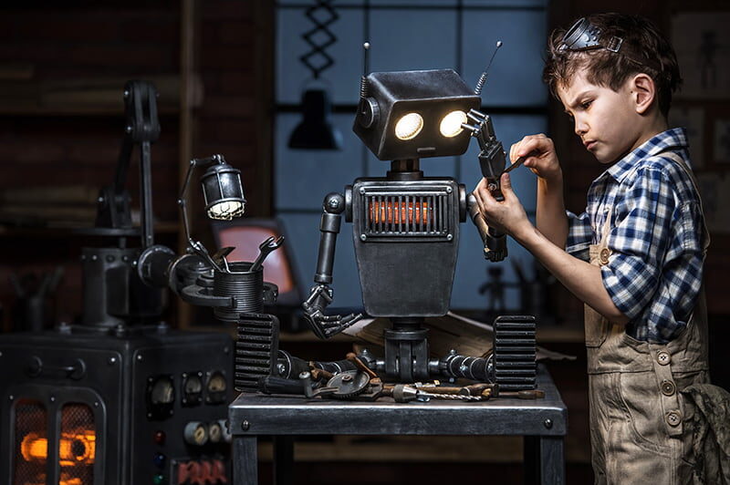 Child engineer working on a robot