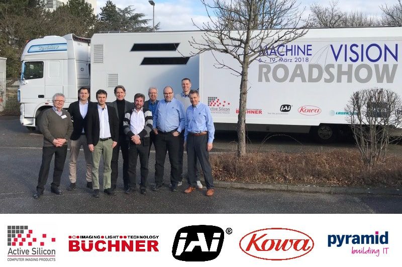 Machine vision experts standing in front of the Machine Vision Roadshow truck