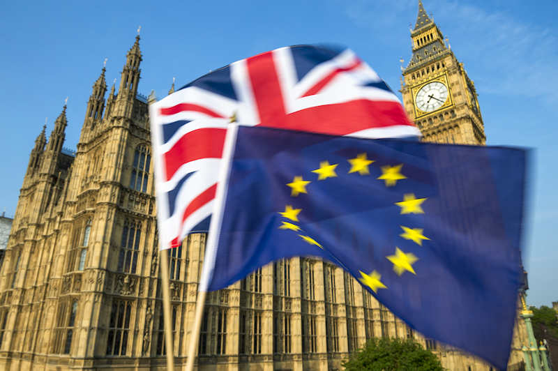 UK union flag and EU flag infront of UK Houses of Parliament