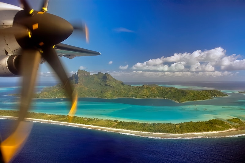 Plane propeller flying over an atoll