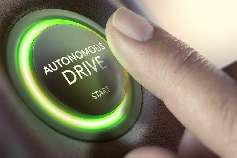 A finger ready to push an autonomous drive button