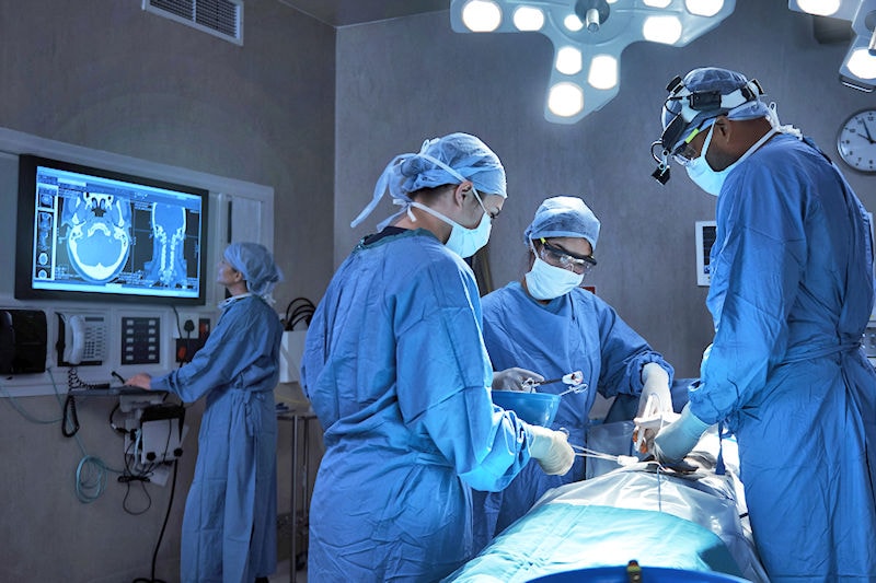 Surgeons in the operating theatre consulting computer images