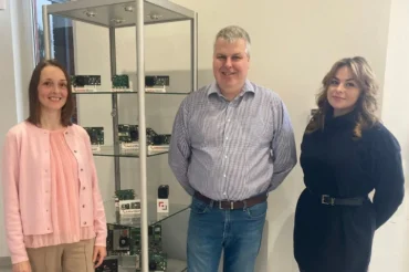 three staff members in front of Active Silicon products