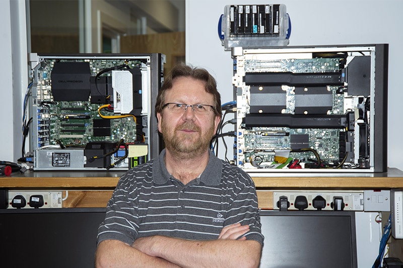 Active Silicon’s Application Support Specialist standing in front of test PCs