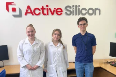 Three young people standing in front of an Active Silicon logo