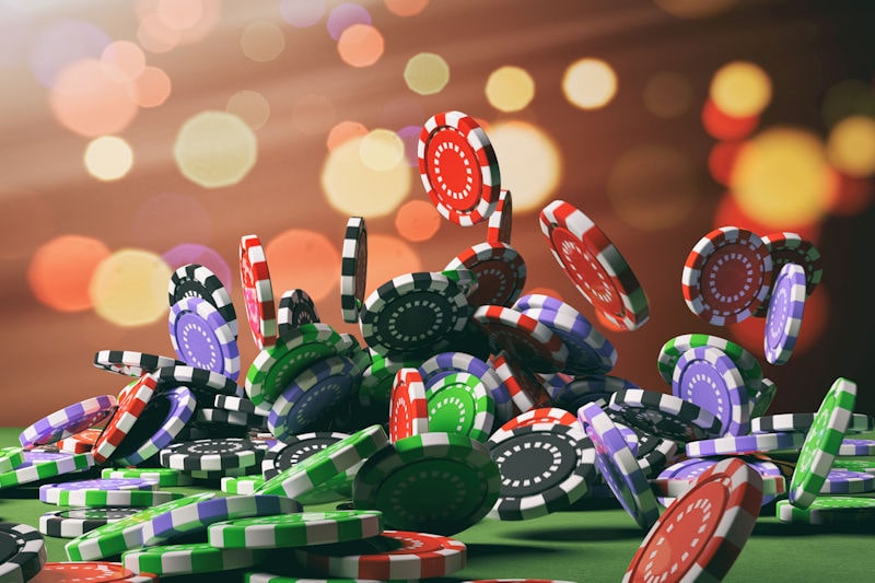 colored casino chips falling onto a roulette table