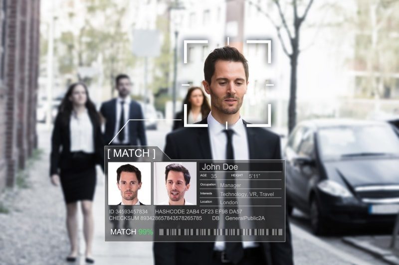 man walking in the street with digital overlay of his identity