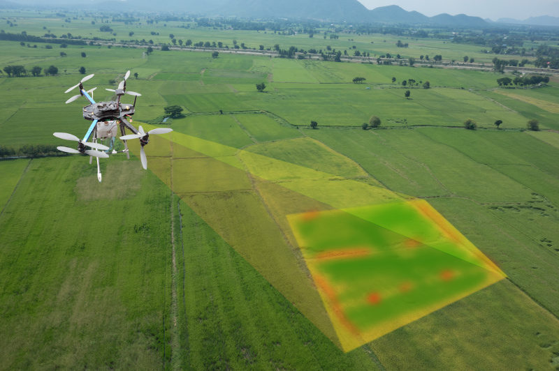 Drone projecting multispectral image onto agricultural land.